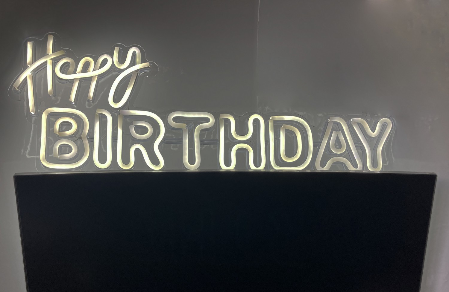 Happy BIRTHDAY illuminated LED sign on the wall